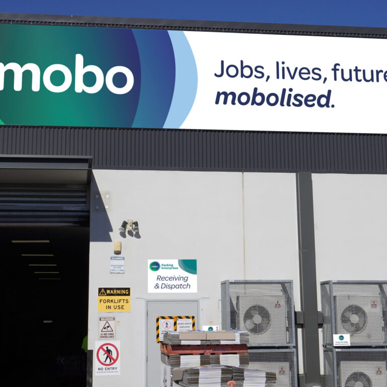 large sign on building that reads mobo, Jobs, Lives, Futures, mobolised.