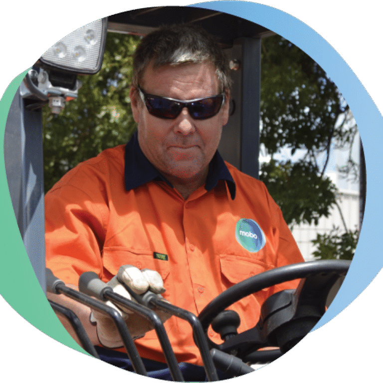 Man in mobo Hi Vis, operating a bucket loader